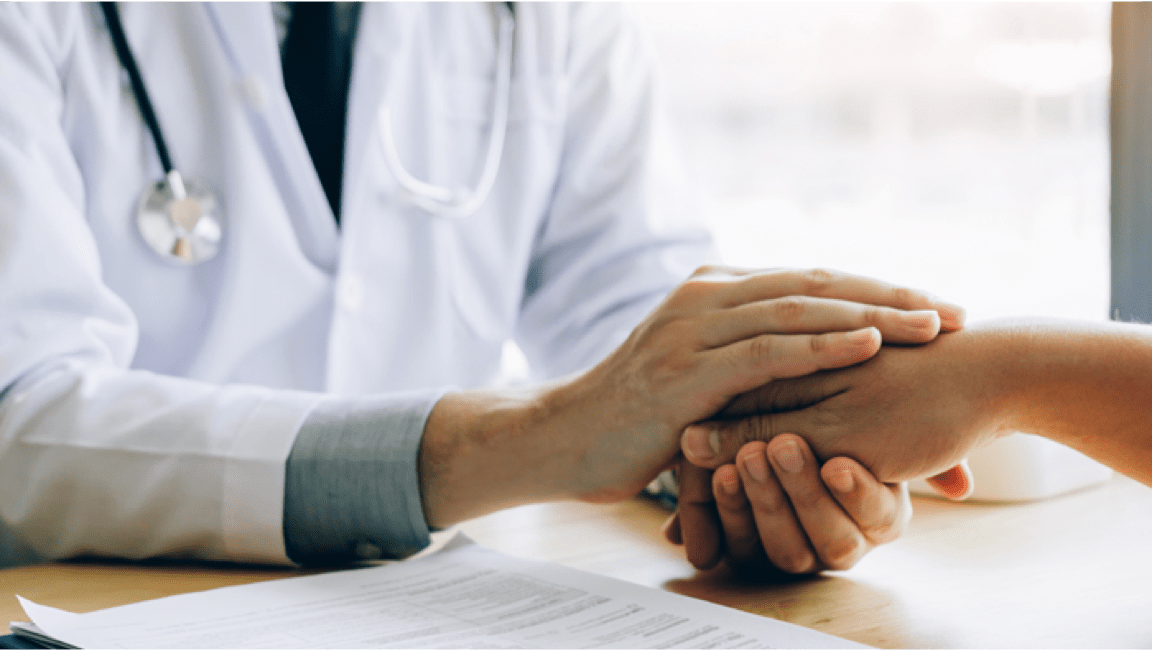 Doctor giving emotional support to a patient